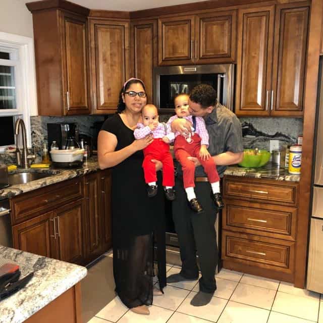 Photo Of Fernanda Adriele Silva with her husband holding their sons In Kitchen